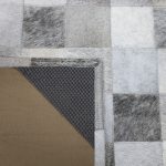 Patchwork hair on hide rug with corner flipped up to show the backing
